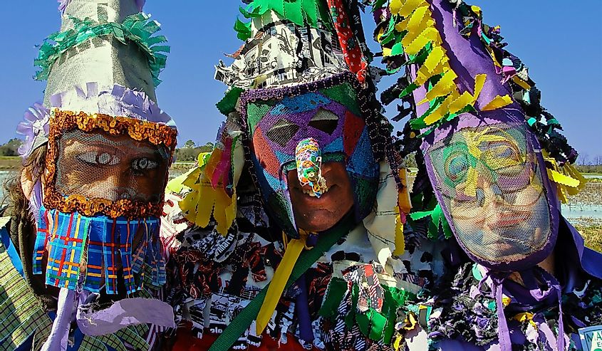 People in colorful masks for Mardi Gras in Eunice. 