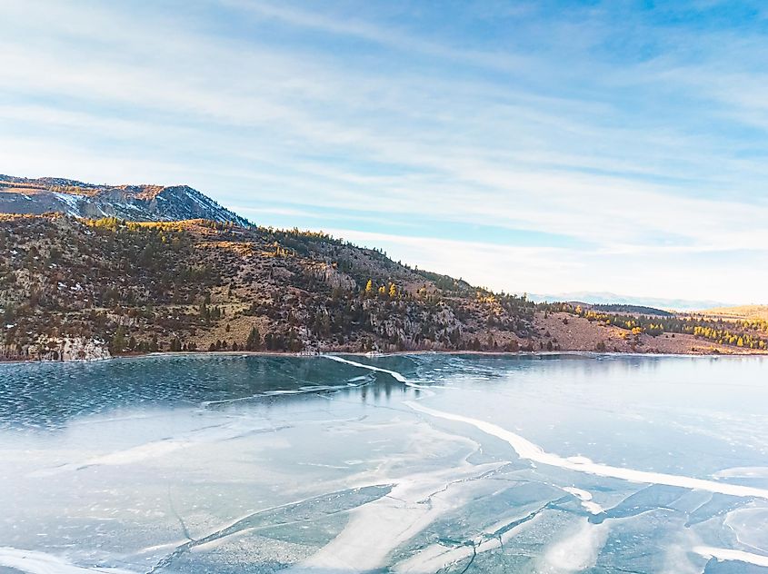 Aerial view of frozen June Lake, California, USA, surrounded by the town and mountains.