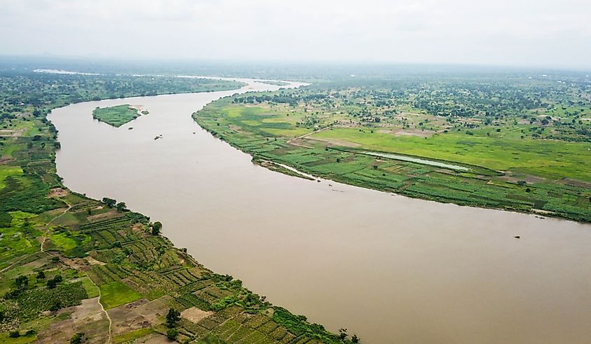 Aerial shot of Benue River with lush vegetation around.