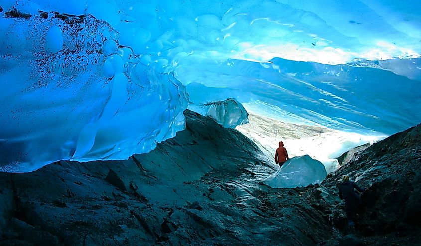 Explorer inside ice cave, Mendenhall Glacier, Juneau, Alaska, USA