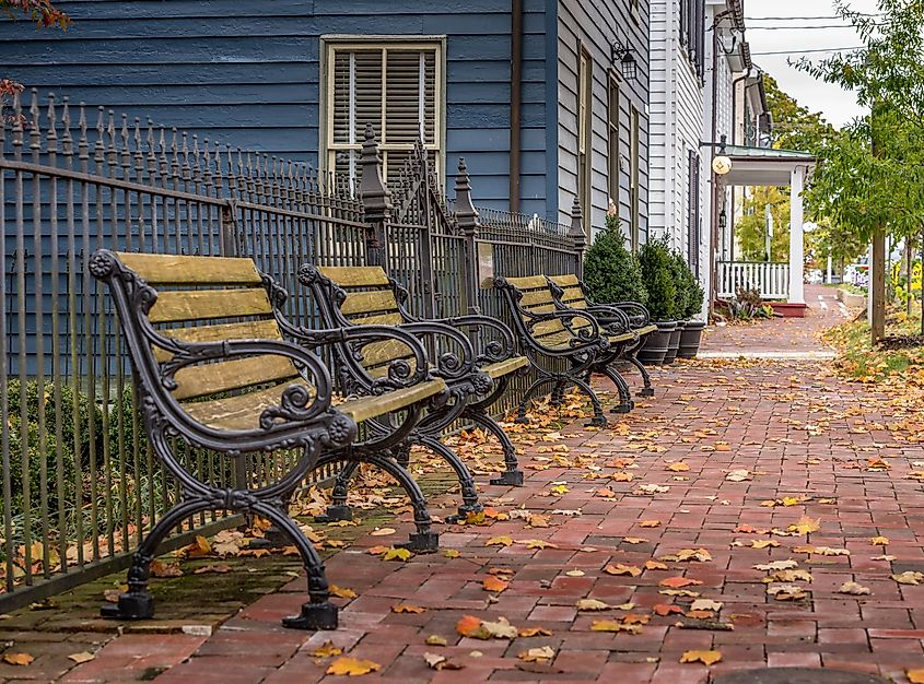 Wooden iron bench on isolated colonial street in New Market