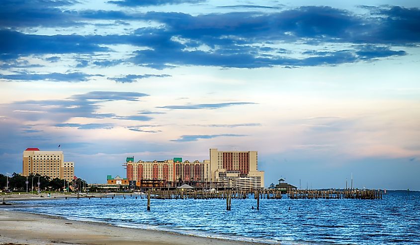 Biloxi, Mississippi, casinos and buildings along Gulf Coast shore at sunset