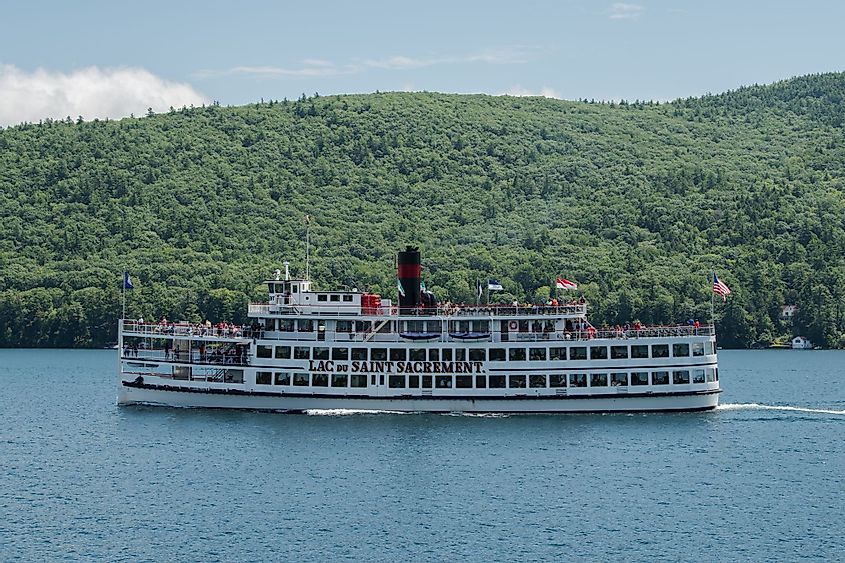 Passenger steamboat carrying tourists on a cruise to see the sights of Lake George waterfront and surrounding Adirondack Mountains. Editorial credit: splask / Shutterstock.com