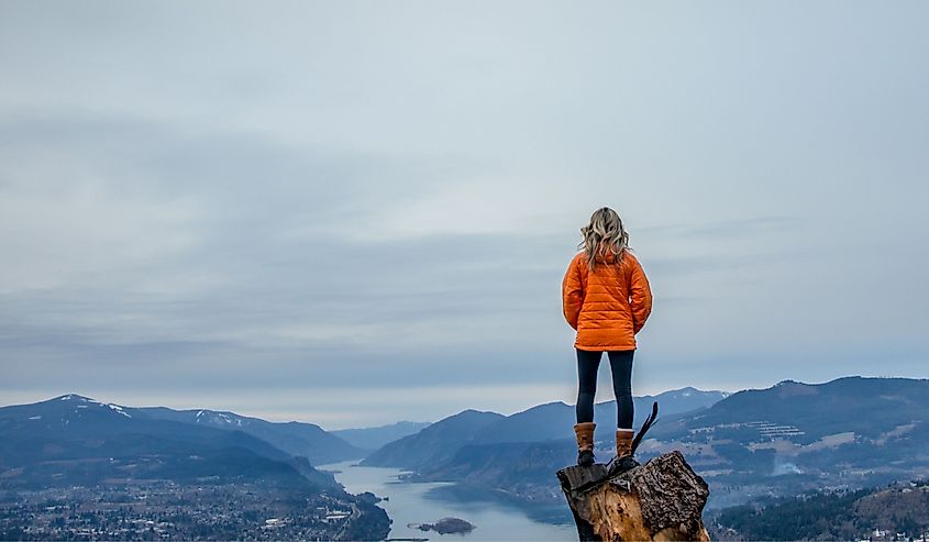 A woman looking at the Columbia River near Hood River in the Columbia River Gorge, Oregon