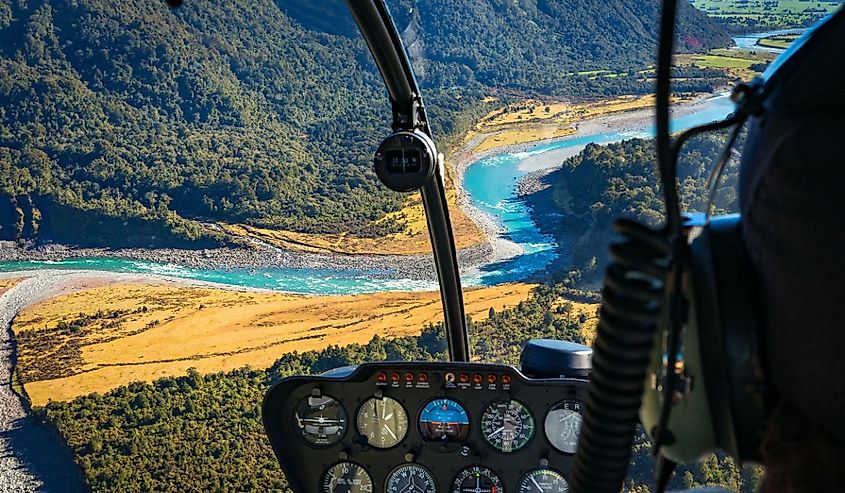 View from helicopter on beautiful landscape of mountain river. Whataroa, South Island, New Zealand.