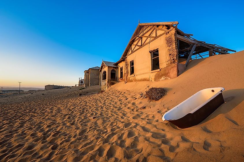 Empty bathtub placed outside in the sand desert around the ghost town of Kolmanskop.