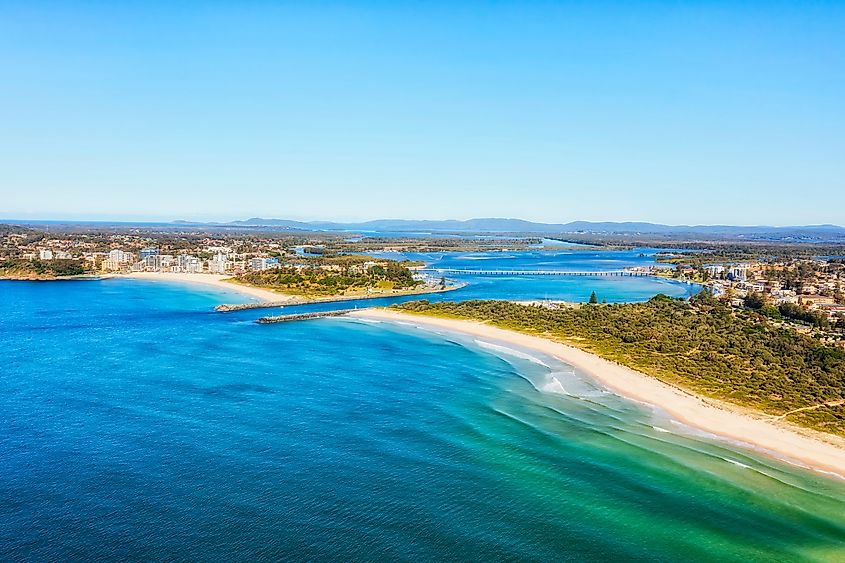 Forster coastal towns of Australian Pacific shore, aerial view towards delta of Wallis lake and bridge.