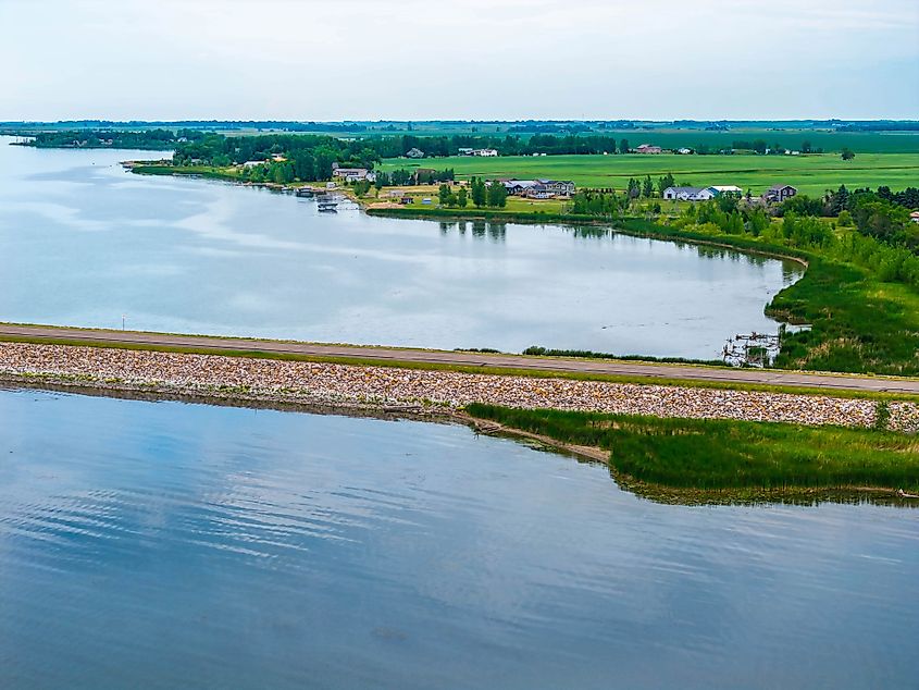 A scenic road extending into Devils Lake, North Dakota.