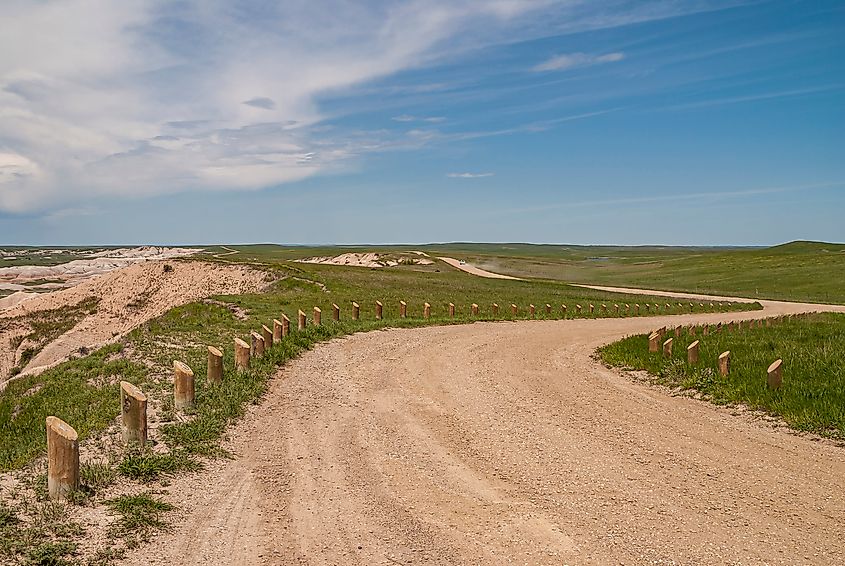 A dirt road meanders through the Badlands near Oglala Lakota County. Via Shutterstock / Claudine van Massenhove