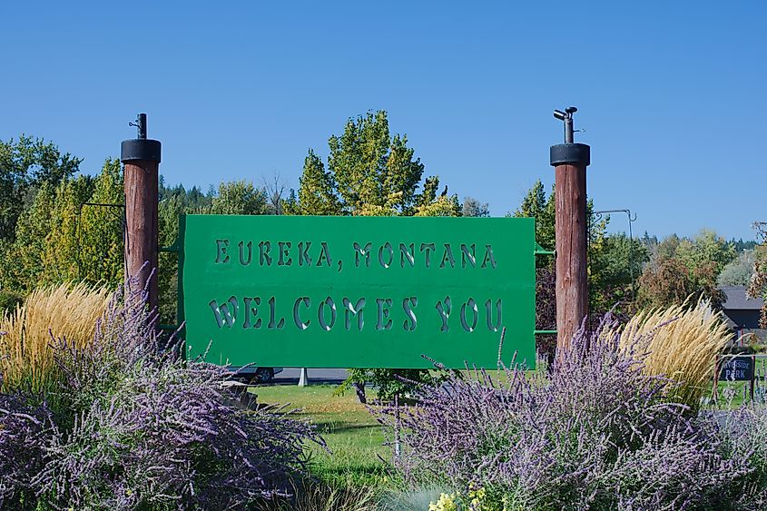 Eureka, Montana Welcome Sign In Garden Landscape With Purple Flowers And Blue Sky. Editorial Use Only USA. Sept 24, 2025. Historical village Colorful welcome sign is framed by lush lavender and orname