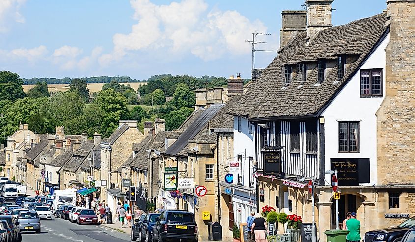 Shops and businesses along The Hill shopping street during the Summertime, Burford, Oxfordshire, England