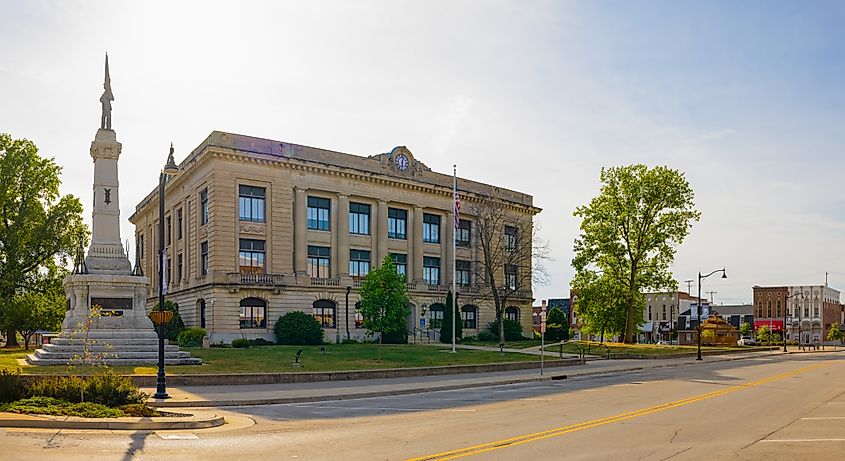 Editorial Photo Credit: Roberto Galan via Shutterstock. Delphi, Indiana, USA - August 23, 2021: The Carroll County Courthouse and it is War Memorial