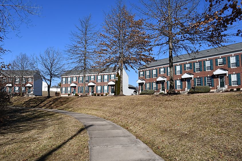 A sidewalk going by some large brick houses in O’Fallon, Missouri.