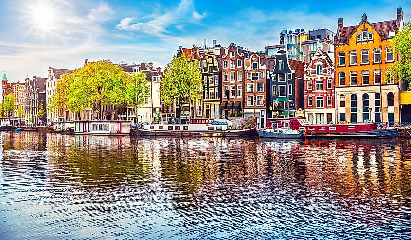 Amsterdam Netherlands dancing houses over river Amstel landmark in old european city spring landscape.