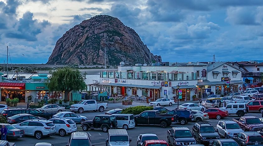 Pier shops and parking lot facing Morro Rock in Morro Bay, California