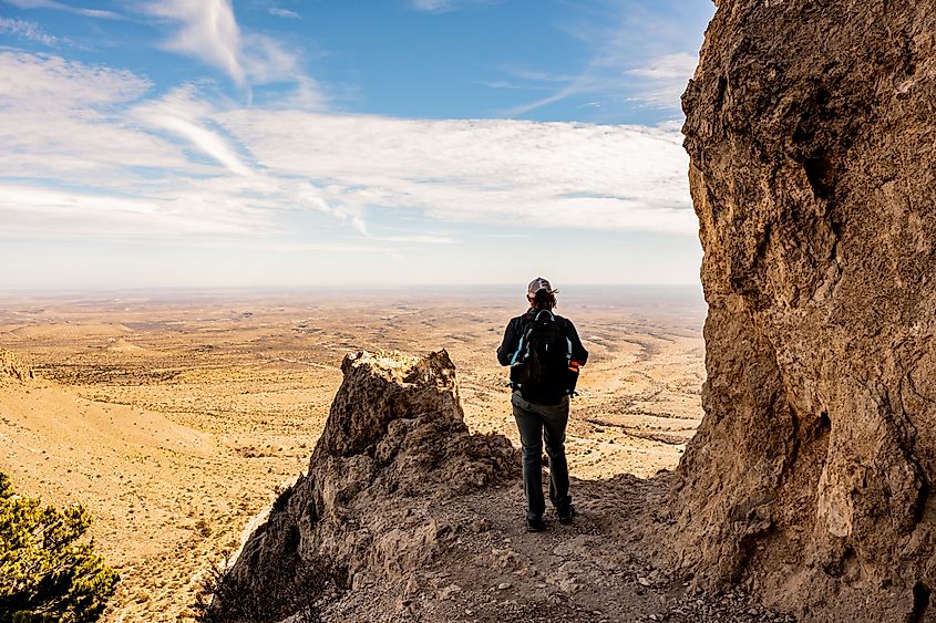 Woman Stands at Viewpoint Over Valley from Guadalupe Peak Trail.