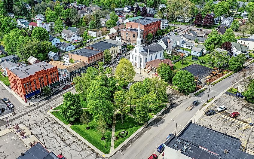Aerial view of the Village of Hammondsport, New York, featuring an old white church, historic buildings, and lush greenery.