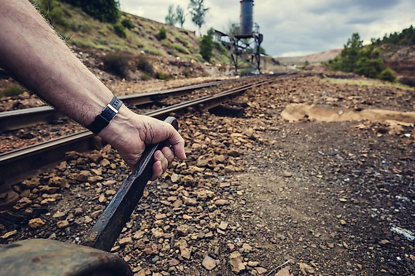 hand pulling the lever to change the way in the old train station of Zaranda, Spain