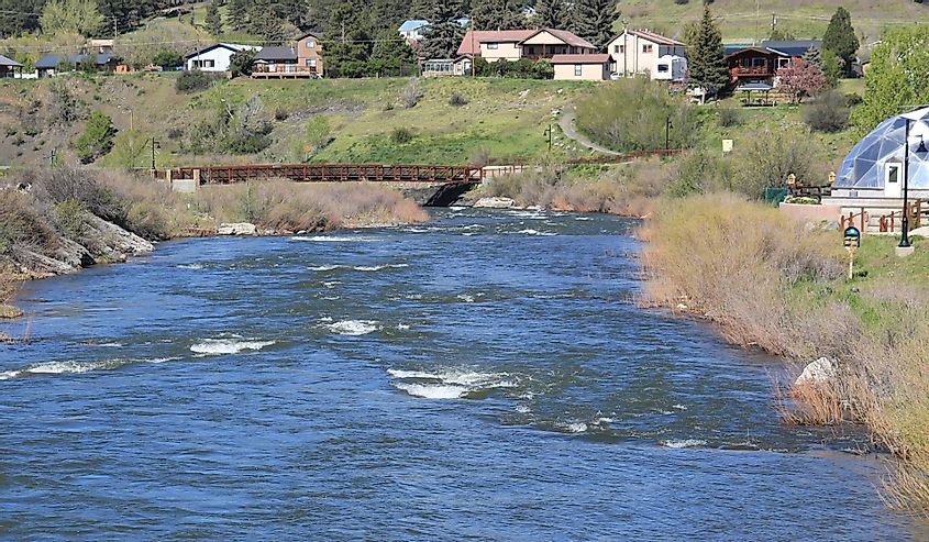 Rapids in High Water of the San Juan River with a Geodesic Dome and Houses in the Background, Pagosa Springs