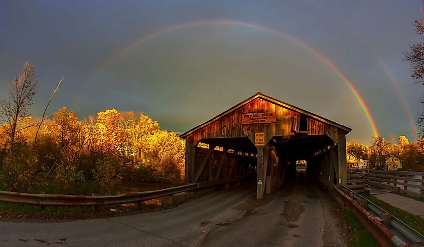 Rainbow over the Pulp Mill Bridge, a covered bridge that spans over Otter Creek in Middlebury, Vermont.