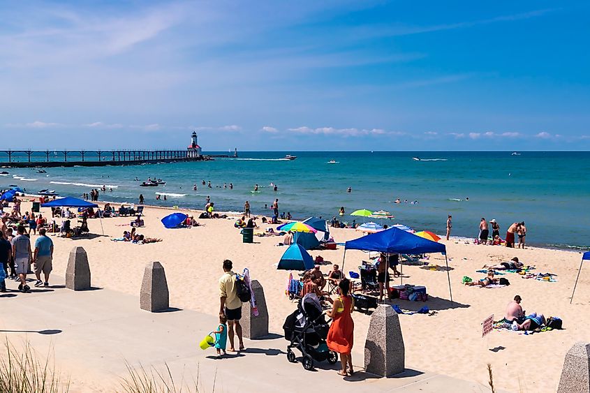 People swimming on the beach in Michigan City, via Lewis Photo Studio / Shutterstock.com