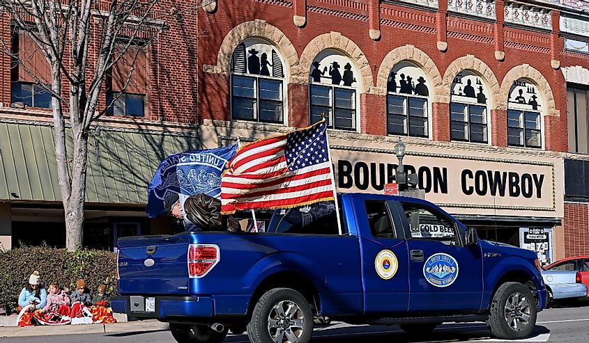 Pickup truck belonging to United States Navy submarine veterans flies the American flag the during the Veterans Day parade in founding town of Veterans Day, Emporia, Kansas