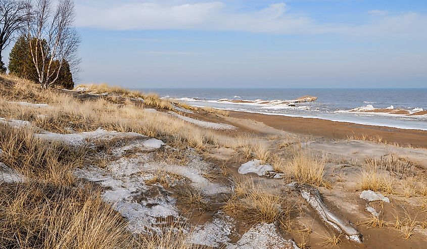 Sandy beach and winter shoreline of Lake Michigan in Two Rivers, WI. 
