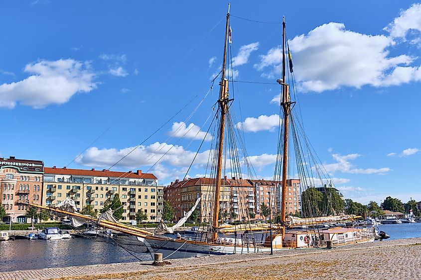 View of Halmstad city center along the Nissan River, with a traditional sailing ship moored at the riverfront in Halmstad, Sweden.