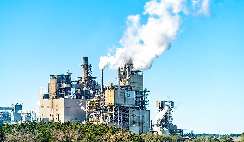 Industrial paper mill factory plant with chimney smokestacks stacks emitting carbon dioxide emission pollution in Georgetown, South Carolina town