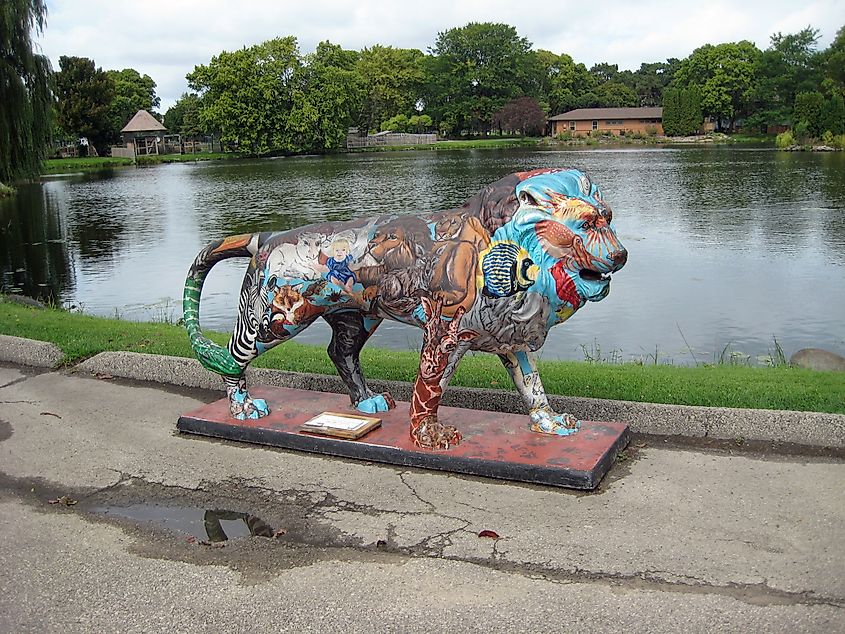 Editorial Photo Credit: Helene Woodbine via Shutterstock. OSHKOSH, WISCONSIN / USA - September 20, 2013: "Pride of Oshkosh" sculpture, "A Peaceable Kingdom," by William Greider, on display at the Menominee Park Zoo 