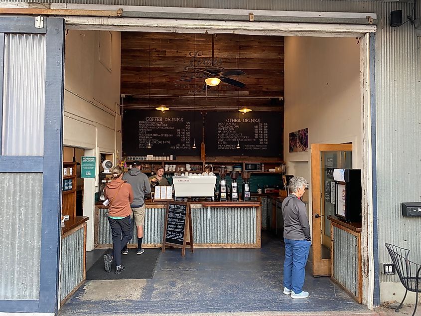 People ordering coffee in a converted industrial coffee shop. 