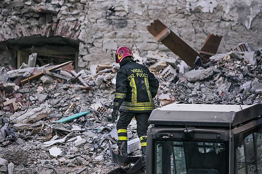 A fireman walks among the ruins during an earthquake in Italy
