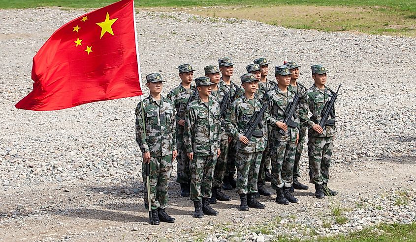 a platoon of Chinese soldiers with the Chinese flag