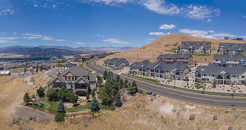 Beautiful houses along roads against blue sky and mountains in Lehi Utah