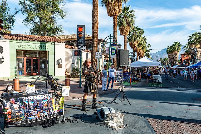 People enjoying the vendors and entertainers at the Palm Springs Street Fair.