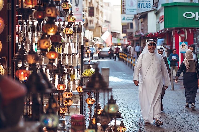 Bahrain city / Bahrain - January 15, 2020: Local Muslim people shopping in souq bazaar area in old town downtown Bahrain, via The Road Provides / Shutterstock.com