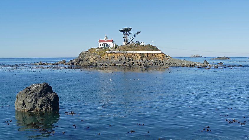 Looking out over the water to a historic lighthouse in Crescent City, California