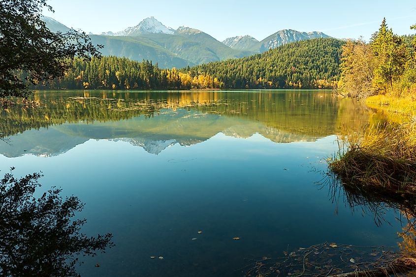 Reflected mountains viewed from the shore of Gun Lake, British Columbia, Canada