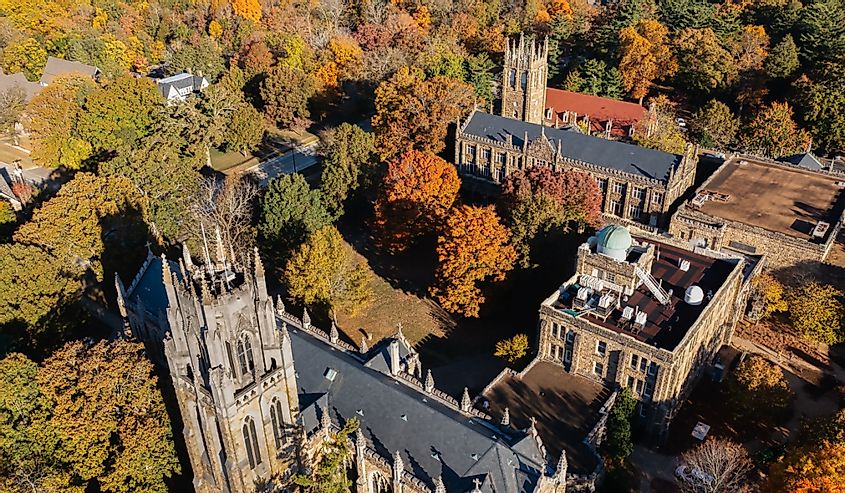 Aerial view of University Ave with a church and tower in the background, on a mountain top October day with beautiful autumn fall colorful foliage at the University of the South in Sewanee Tennessee.