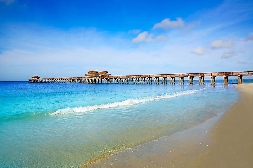 Naples Pier and beach in Naples, Florida on a sunny day. 