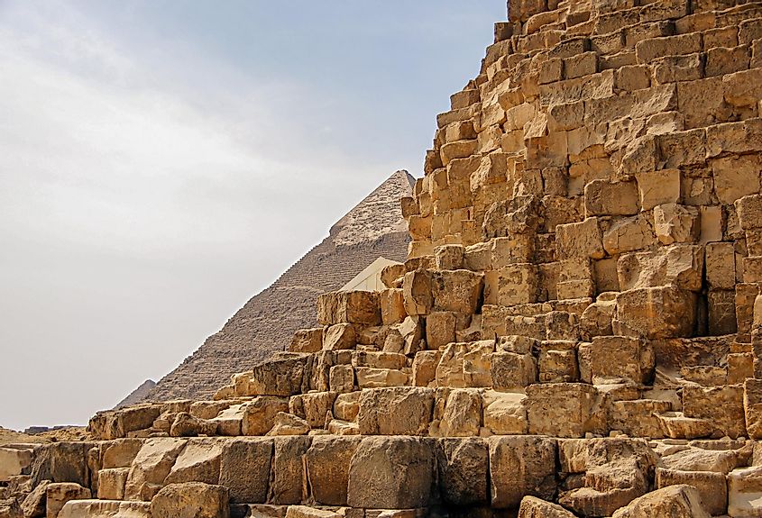 Ancient Egyptian pyramid of Giza against the sky and close up of the pyramid blocks