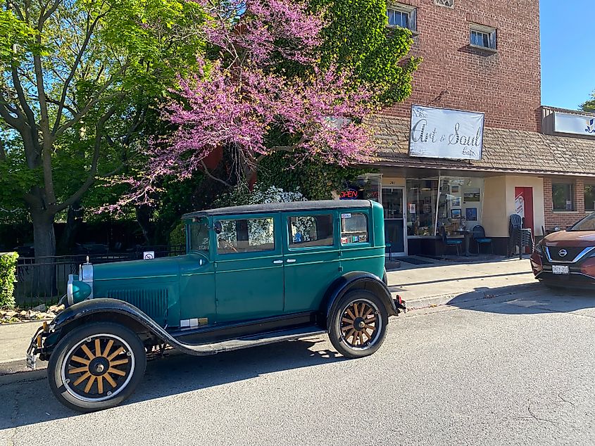 An old Model-T car sits parked in front of The Art and Soul Cafe on a beautiful spring morning.
