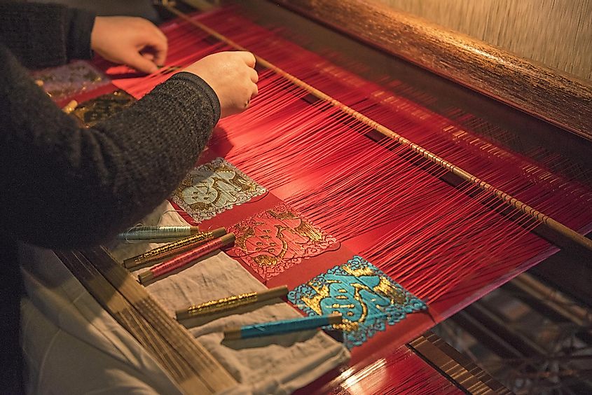 A woman weaving traditional chinese silk in Wuzhen, China
