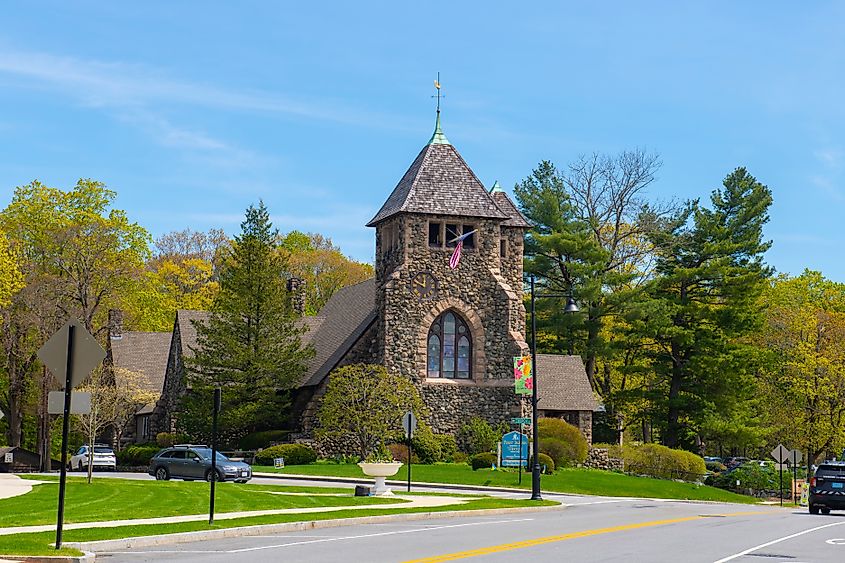 First Parish Church at 349 Boston Post Road in the historic town center of Weston, Massachusetts, surrounded by spring blooms.
