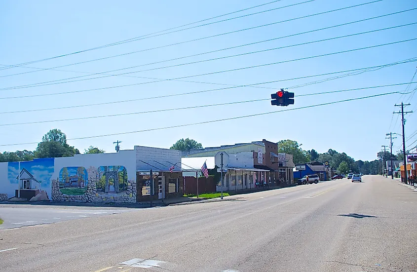 Buildings lining Main Street in Tishomingo, Mississippi, including small storefronts and brick facades along the roadside
