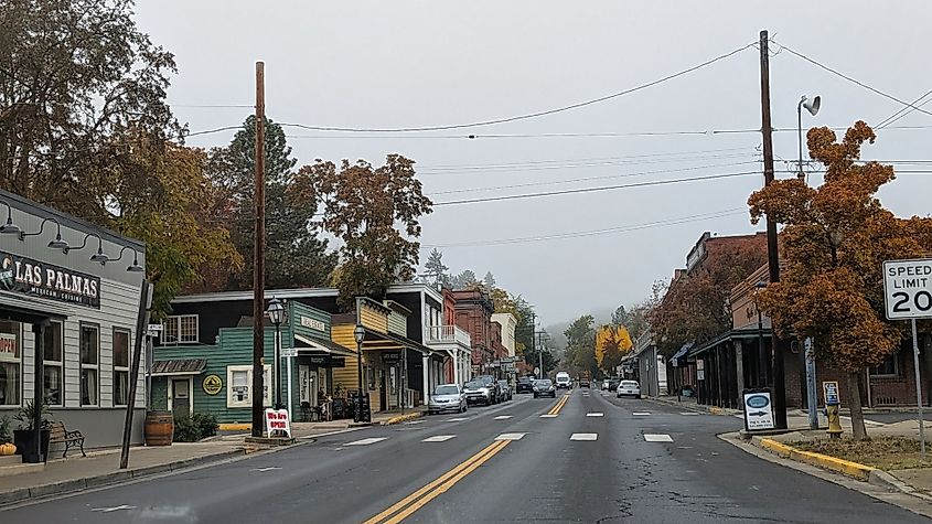 Jacksonville, Oregon. Historic Main Street lined with old-west-style buildings, rustic storefronts and a few modern touches, blending past and present in a lively small-town streets.