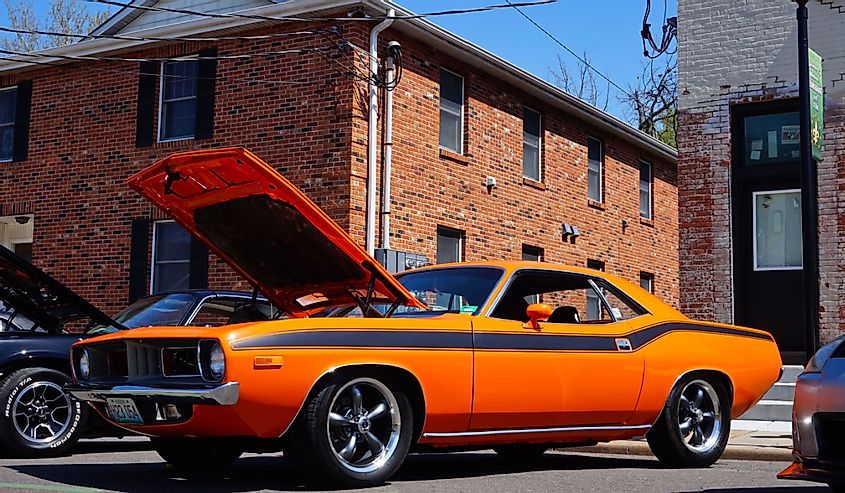 A classic v8 Hemi powered muscle car with the hood open.