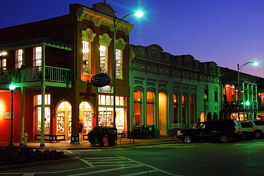 Square Books, a famed independent bookstore, glowing against the dusk sky in Oxford, Mississippi, USA.