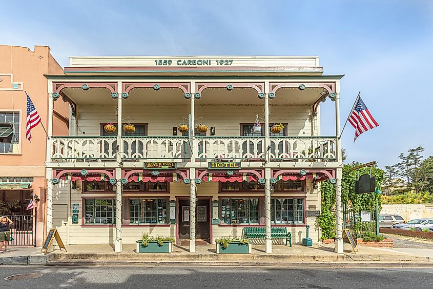 Old historic Carboni building from 1859 with typical two-story architecture, wooden facade, and balcony in Jamestown, California, USA.