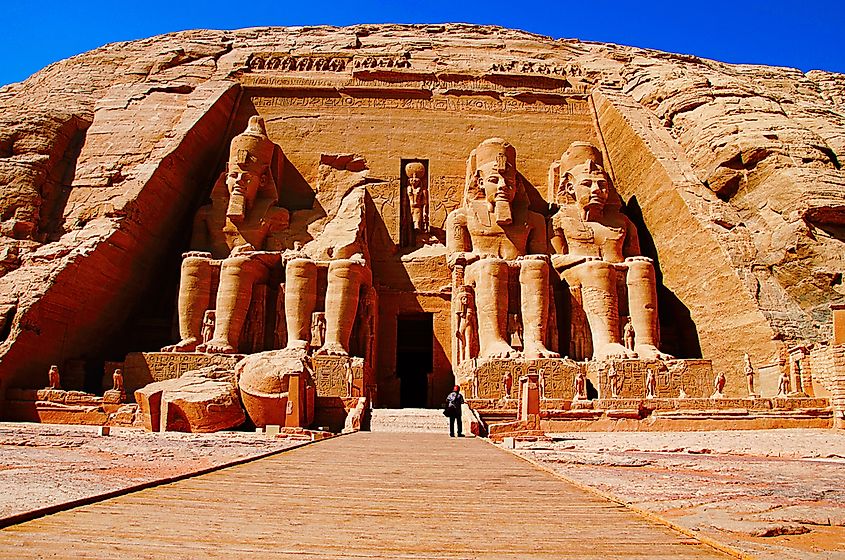 Carved figures of Egyptian kings on a temple wall, depicting the pharaoh as both ruler and divine intermediary.